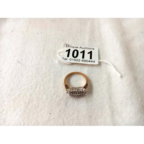 1011 - A yellow gold baguette and brilliant diamond ring, size O half, 4 grams.