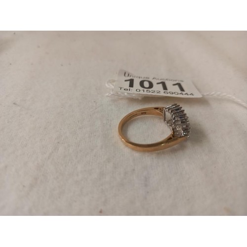 1011 - A yellow gold baguette and brilliant diamond ring, size O half, 4 grams.