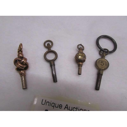 1049 - Four old pocket watch keys (one may be gold).