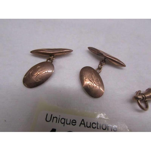 1050 - A pair of 9ct gold cuff links and a 9ct gold watch clip. 6.4 grams.