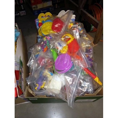 153 - A box of unopened McDonald toys including Peter Pan, Walt Disney & Smurfs etc. & a box full of opene... 