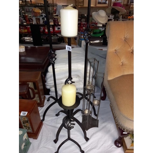 179 - A set of 4 graduated black metal candlesticks & 1 other 5 tea light holder COLLECT ONLY