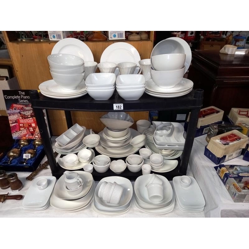 182 - A large selection of white glazed dinner/table ware.