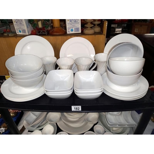 182 - A large selection of white glazed dinner/table ware.