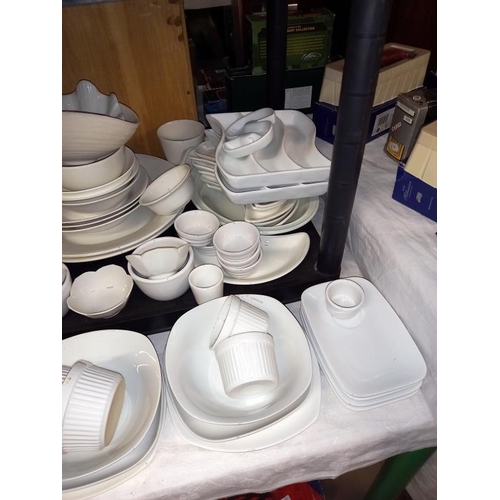 182 - A large selection of white glazed dinner/table ware.