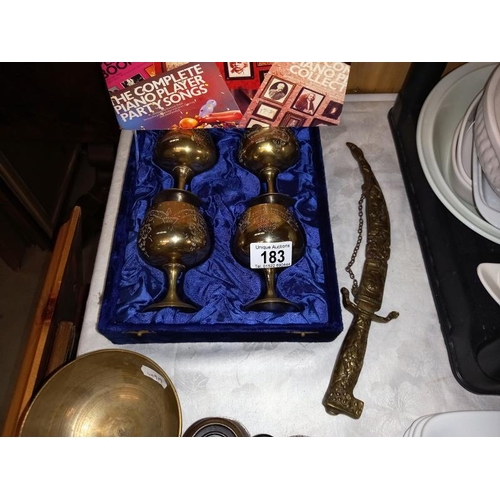 183 - 4 cased brass goblets, brass ceremonial daggers, old binoculars etc