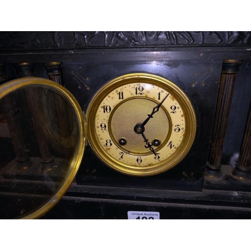 192 - A black slate mantle clock with 6 brass reeded columns, no key, no pendulum, 1 spring broken 1 over ... 