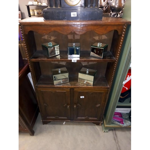 196 - A 1920's oak bookcase with 2 cupboard doors (80cm x 21cm x 125cm high)