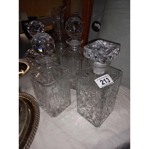 213 - 4 cut glass decanters including Royal Doulton, including a vase.