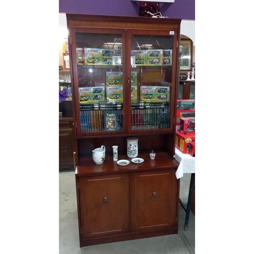 236 - A dark wood stained wall unit with cut glass doors (45cm x 92 cm x 196 cm high). Collect Only.