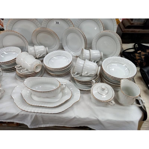 304 - A Chodziez made in Poland, white dinner service with gilded rims.