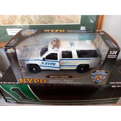 496 - 2 Jada NYPD 1:24 fire engines and 2 American Racing limited edition Diecast models.