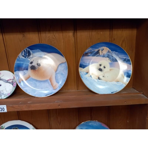 530 - A collection of seal related items including 6 x Franklin mint limited edition porcelain plates, tit... 