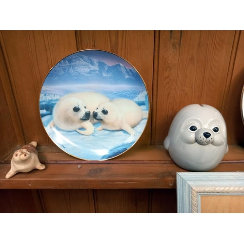 530 - A collection of seal related items including 6 x Franklin mint limited edition porcelain plates, tit... 