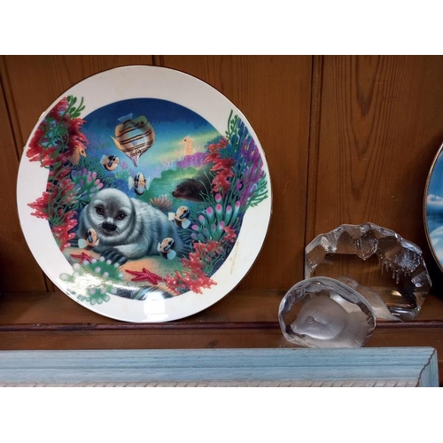 530 - A collection of seal related items including 6 x Franklin mint limited edition porcelain plates, tit... 