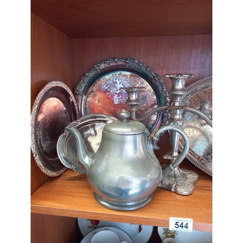 544 - A quantity of silver plate and pewter including candelabra, trays etc. 2 shelves.