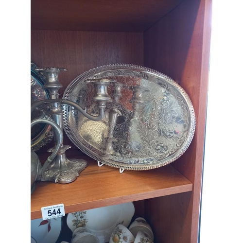 544 - A quantity of silver plate and pewter including candelabra, trays etc. 2 shelves.