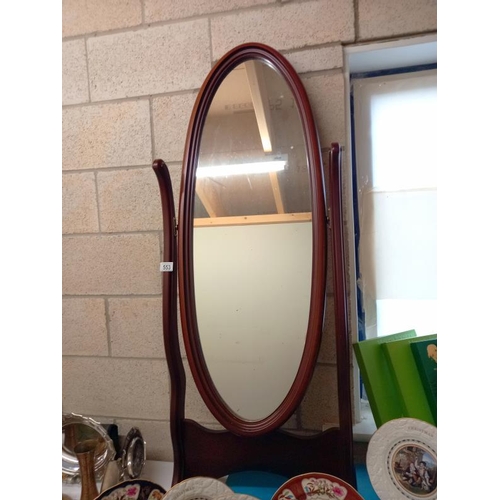 553 - A dark wood stained cheval mirror.