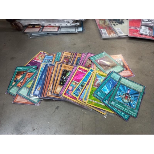 566 - A box of Pokemon cards, magic the gathering cards, and a mix of graphic comics (various publishers) ... 