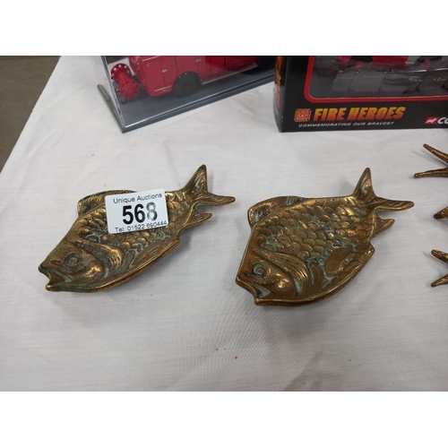 568 - A set of 3 brass graduate bird wall ornaments and 2 fish dishes.