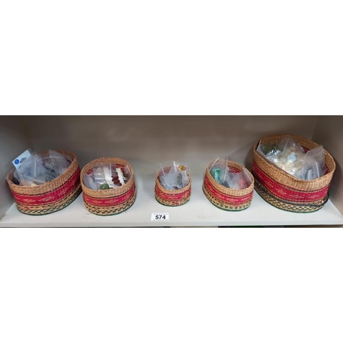 574 - A good selection of vintage buttons in graduated wicker lidded baskets.