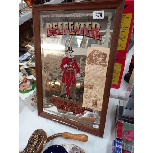 578 - A vintage Beefeater advertising mirror, Pusser's rum ships decanter and heavy brass bar top corkscre... 