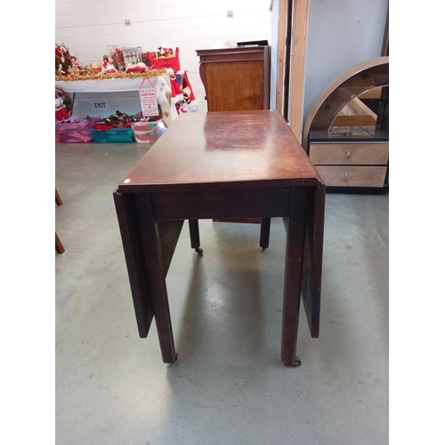 584 - A 19th century mahogany Pembroke table on casters.