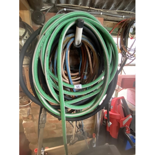 65 - A collection of various pipes and hoses, welding torch, large blow torch and pressure washer hoses. ... 