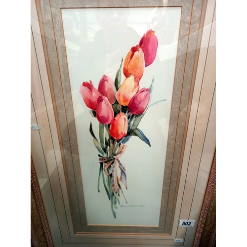 502 - An ornate framed picture of tulips. 57cm x 87cm.