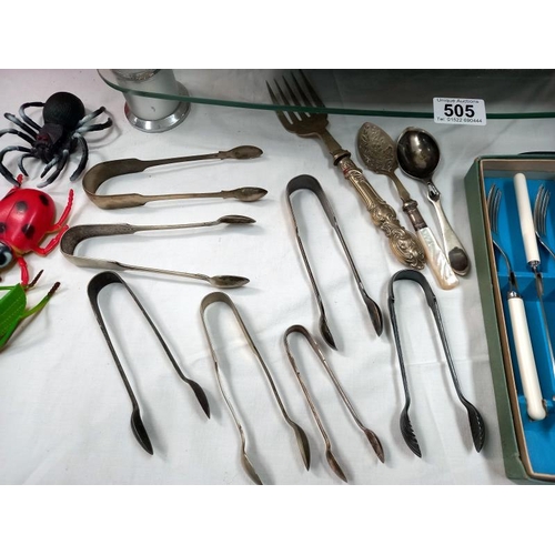 505 - A quantity of silver plated flatware including sugar tongs.