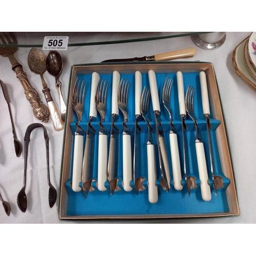 505 - A quantity of silver plated flatware including sugar tongs.