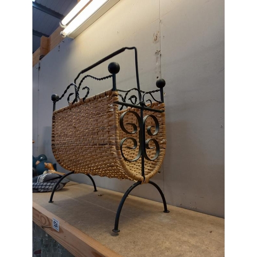 524 - A wrought iron and wicker magazine rack.