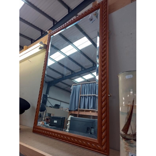 528 - A pine framed mirror.