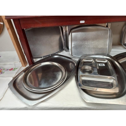 550 - A quantity of stainless steel serving dishes.