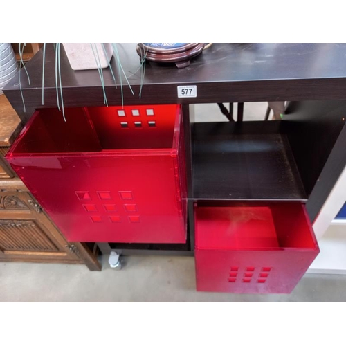 577 - A black ask finished storage unit with dark red plastic drawers. Collect Only.