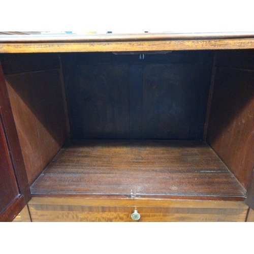 582 - A modern solid wood TV cabinet. Opening doors over drop down front. Collect Only.