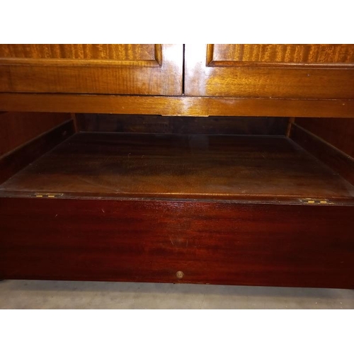 582 - A modern solid wood TV cabinet. Opening doors over drop down front. Collect Only.