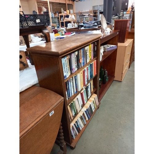 590 - An oak veneer bookcase 83 cm x 33cm x 109cm. Collect Only.