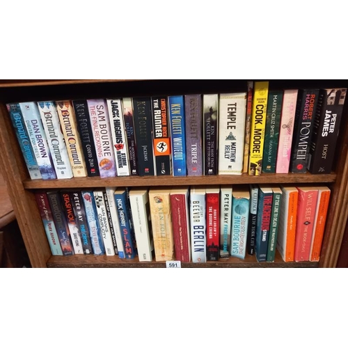 591 - A quantity of paperback books, including Bernard Cornwell and Peter May, etc.