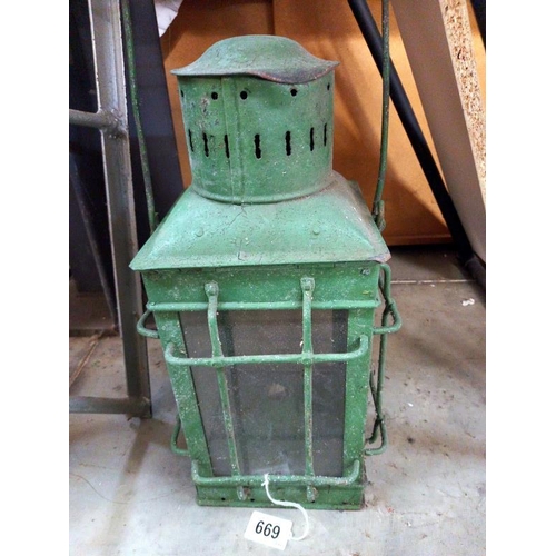 669 - A green painted metal candle lantern.