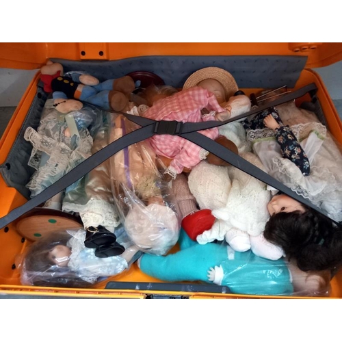 674 - A suitcase of Doll's including Popeye, porcelain black doll & boy Doll etc. Collect only