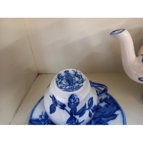 676 - A blue & white Ironstone teapot & 2 matching cups & saucers