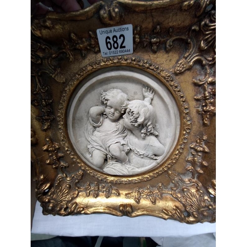 682 - A gilded plaque with mother & child in the centre