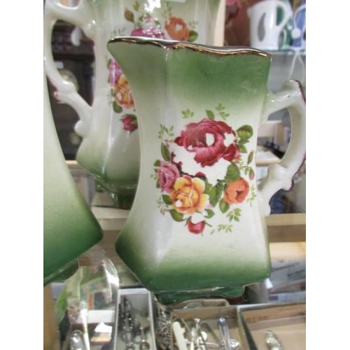 762 - A set of three floral decorated jugs.