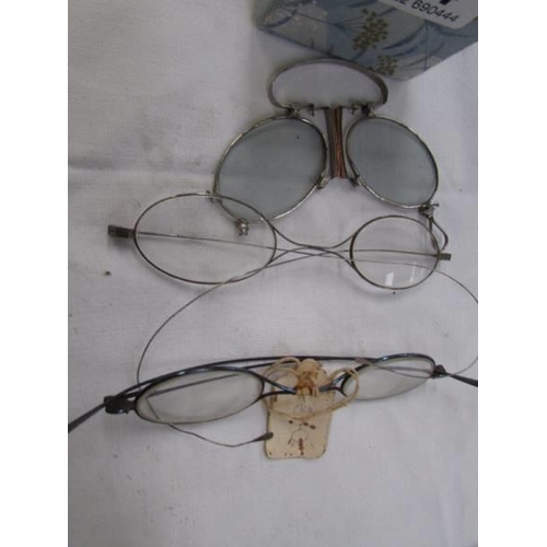 764 - Three pairs of vintage spectacles.