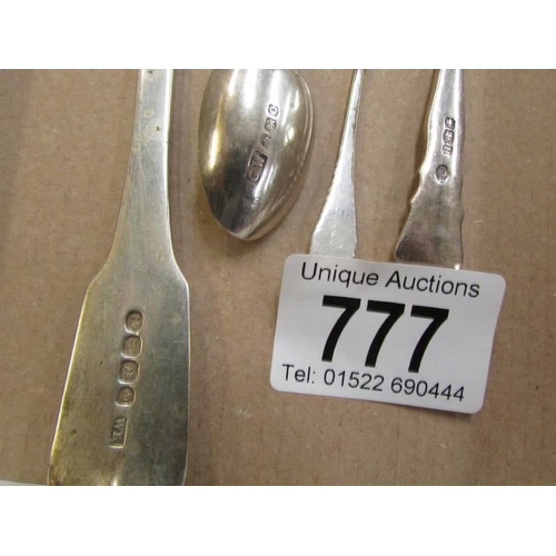 777 - A silver backed hand mirror and a silver spoon.