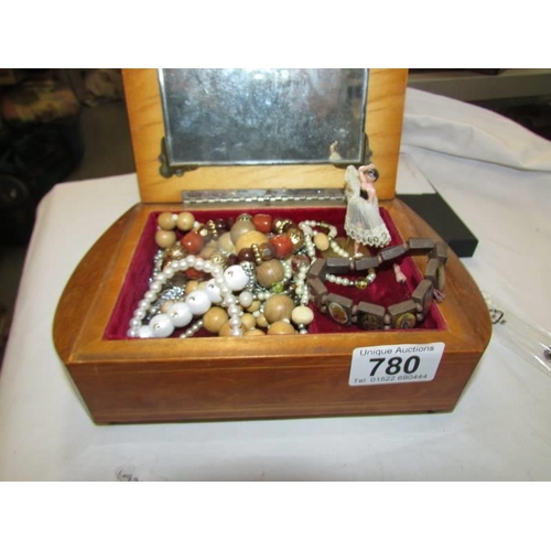 780 - A musical jewellery box and jewellery.