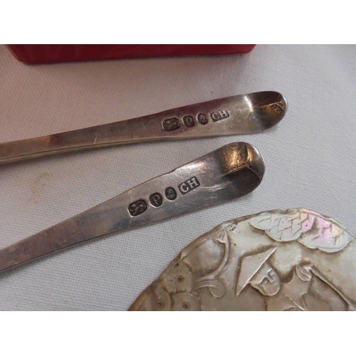 781 - Two silver spoons, a cigarette holder and a mother of pearl plaque etc.,