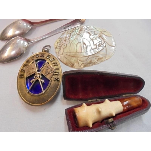 781 - Two silver spoons, a cigarette holder and a mother of pearl plaque etc.,