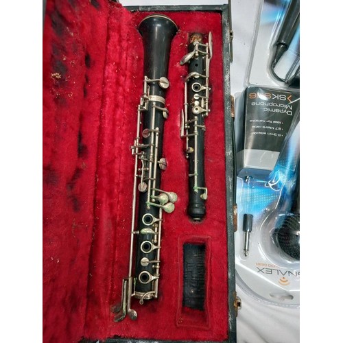 745 - A cased oboe, (No mouth piece) a music stand and two new microphones.